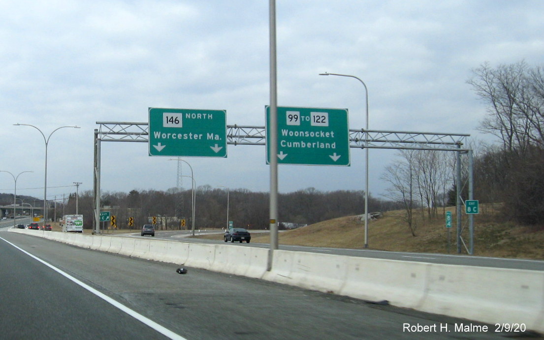 Image of recently placed Exit 8C sign on support posts for overhead signs at RI 99 exit off of RI 146 North in Lincoln