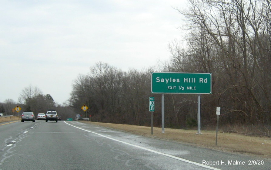 Image of recently placed ground mounted gore sign for Sayles Hill Road, without an exit number, on RI 146 South in North Smithfield