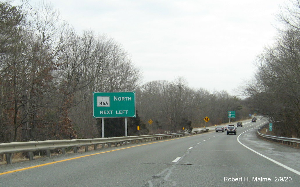 Image of recently placed ground mounted guide sign regarding upcoming left for RI 146A North on RI 146 South in North Smithfield