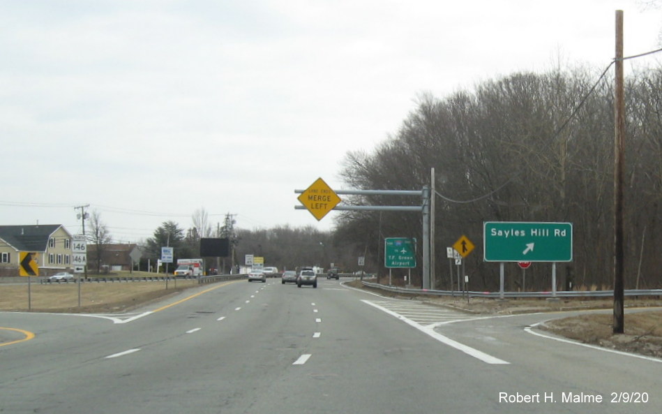 Image of recently placed ground mounted sign for Sayles Road exit at ramp to RI 146A North on RI 146 South in North Smithfield