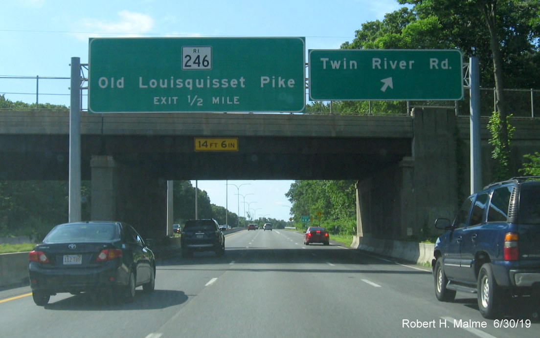 Image of overhead signs and new exit number gore tabs at Twin River Road exit on RI 146 South in Lincoln