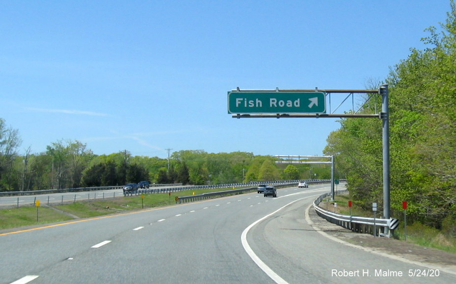 Image of current Fish Road overhead exit sign with new future sign gantry behind on RI 24 South in Tiverton, taken May 2020