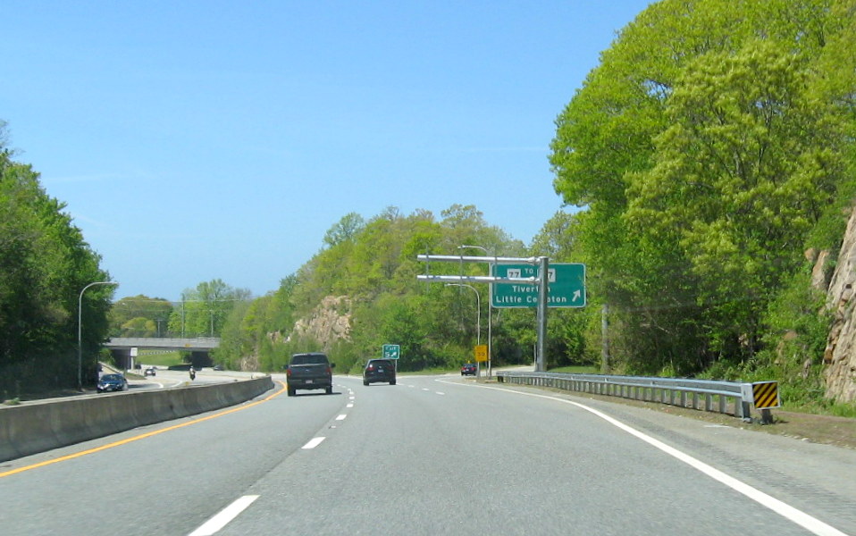 Image of overhead sign gantry awaiting new RI 77 exit ramp sign in front of existing sign on RI 24 South in Tiverton, taken in May 2020