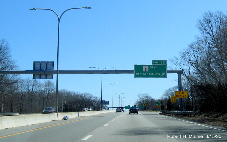 Image of overhead ramp sign for RI 2 South exit on RI 37 East in Cranston with new exit number and old exit number sign mounted on support post, taken in March 2020