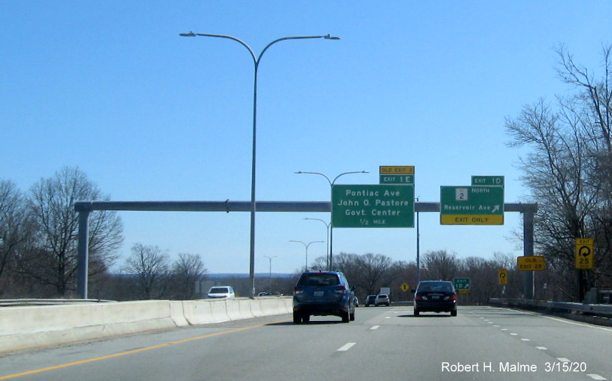 Image of overhead signage at ramp to RI 2 North on RI 37 East in Cranston with new exit numbers and old exit number tabs, one on top, taken in March 2020