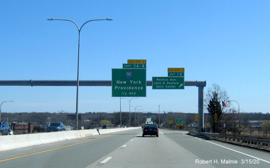 Overhead signage at ramp to Pontiac Avenue on RI 37 East in Cranston with new exit numbers and old exit number tabs on top of signs, taken in March 2020