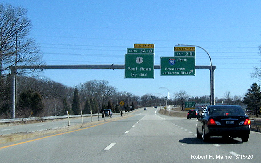 Image of overhead signage at ramp to I-95 North on RI 37 East in Cranston featuring new exit numbers and old exit number tabs on top of signs, taken in March 2020