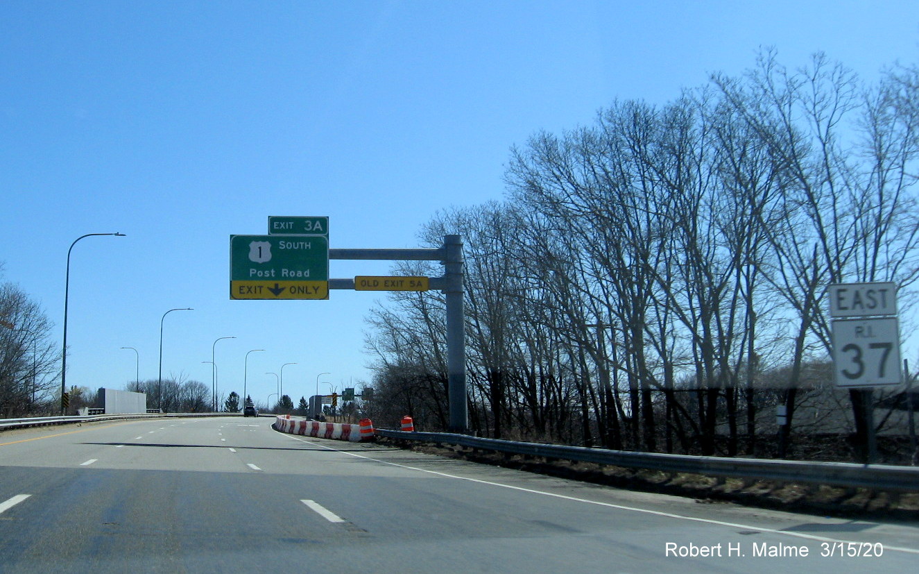 Image of overhead 1/4 mile advance sign for US 1 South exit on RI 37 East in Cranston with new exit number and old exit number tab on support beam, taken in March 2020