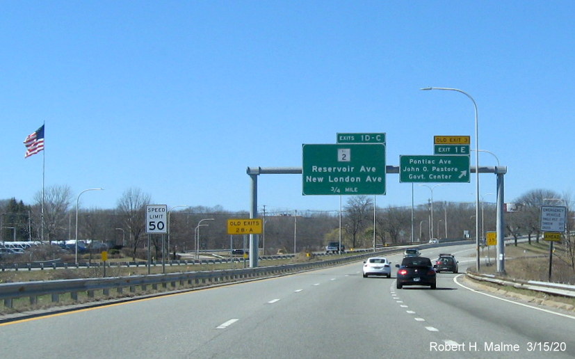 Image of overhead signage at ramp to Pontiac Avenue on RI 37 West in Cranston with new exit numbers and old exit number tabs, one on top of sign, taken in March 2020