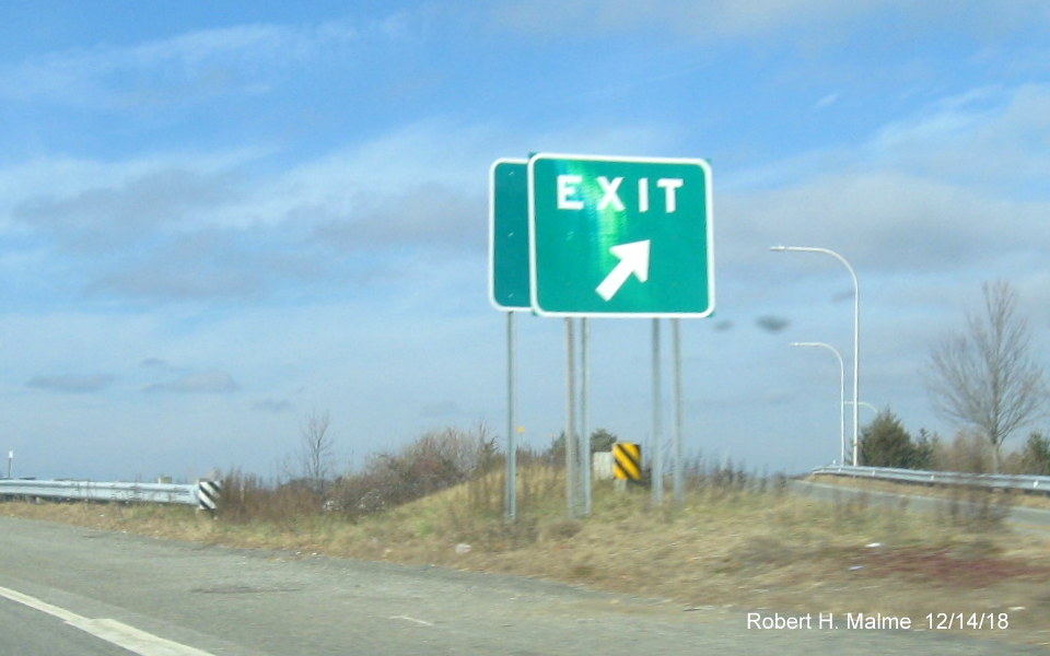 Image of new Exit 3 gore sign hidden behind existing exit sign for US 1 exit on RI 403 West in East Greenwich