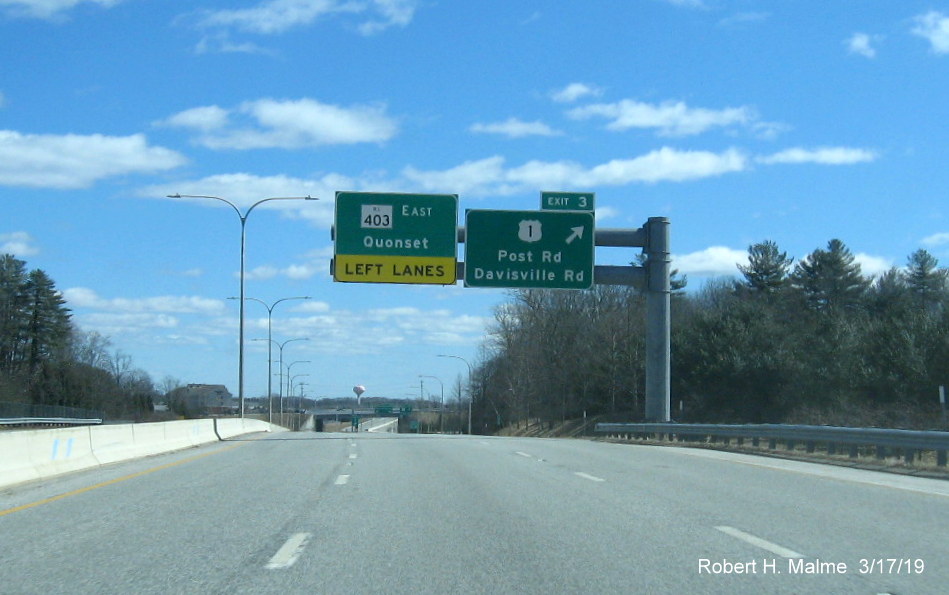 Image of existing overhead signs with new exit number tab for US 1/Davisville Road exit on RI 403 East in Davisville
