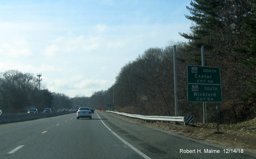 Image of sign posts for new 1./2 mile advance sign with new exit numbers for RI 102 exit on RI 4 South in East Greenwich