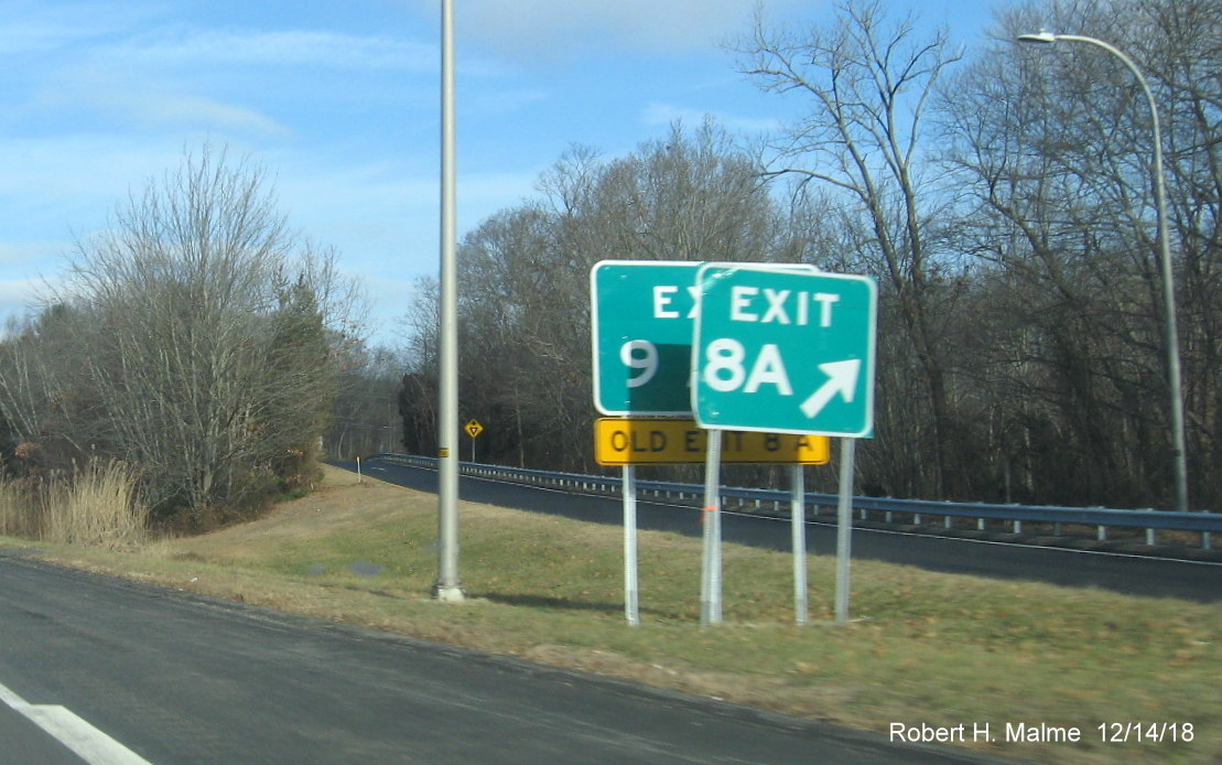 Image of new Exit 9A gore sign up behind soon to be removed Exit 8A sign for RI 401 East exit on RI 4 North in East Greenwich