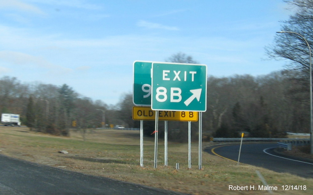 Image of newly placed Exit 9B gore sign with Old Exit 8B tab hidden behind existing Exit 8B sign for RI 401 West exit on RI 4 North in East Greenwich
