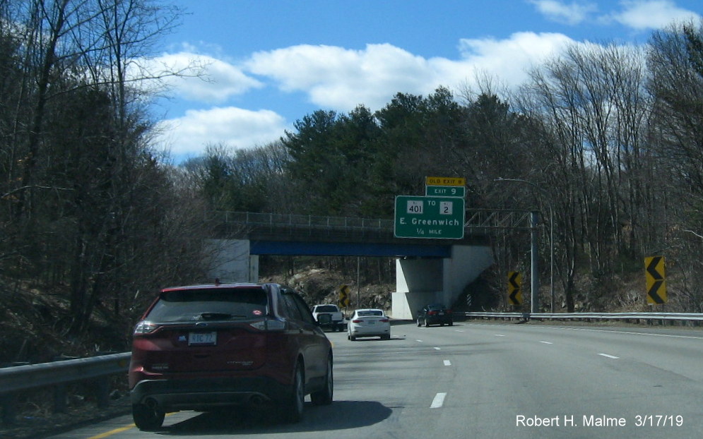 Image of first new overhead advance sign with new exit number and old exit number tab on RI 4 South in East Greenwich