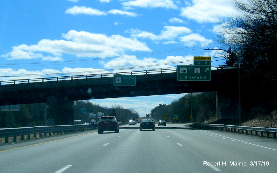 Image of new overhead ramp sign with new exit number and old exit number tab on RI 4 South in East Greenwich