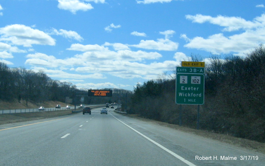 Image of new 1-Mile advance sign with new exit number and old exit number tab for RI 2/RI 102 exit on RI 4 South in Exeter