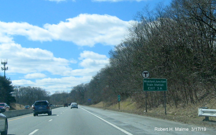Image of revised auxiliary sign with new exit number for train station for RI 2/RI 102 exit on RI 4 South in Exeter