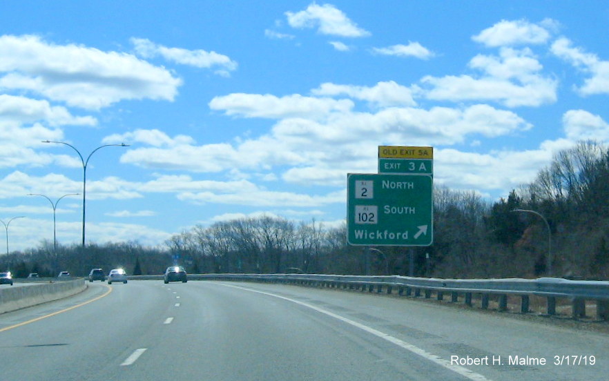 Image of new ramp sign with new exit number and old exit number tab for RI 2 North/RI 102 South exit on RI 4 South in Exeter
