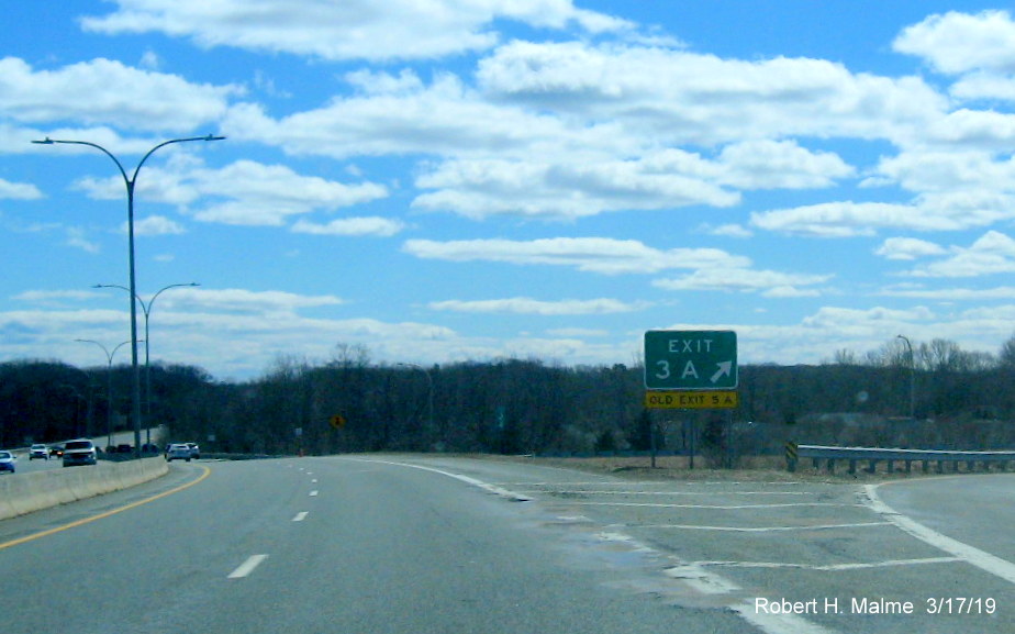 Image of new gore sign with new exit number and old exit number tab for RI 2 North/RI 102 South exit on RI 4 South in Exeter