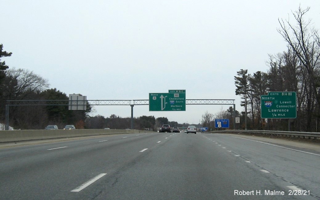 Image of 1/4 Mile advance overhead sign for I-495 North /Lowell Connector exits with new milepost based exit numbers on US 3 North in Chelmsford, February 2021