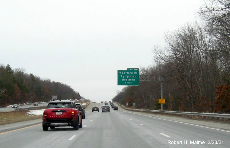 Image of 1-Mile advance overhead sign for the Westford Road exit with new milepost based exit number and yellow old exit number sign below on US 3 North in Tyngsborough, February 2021