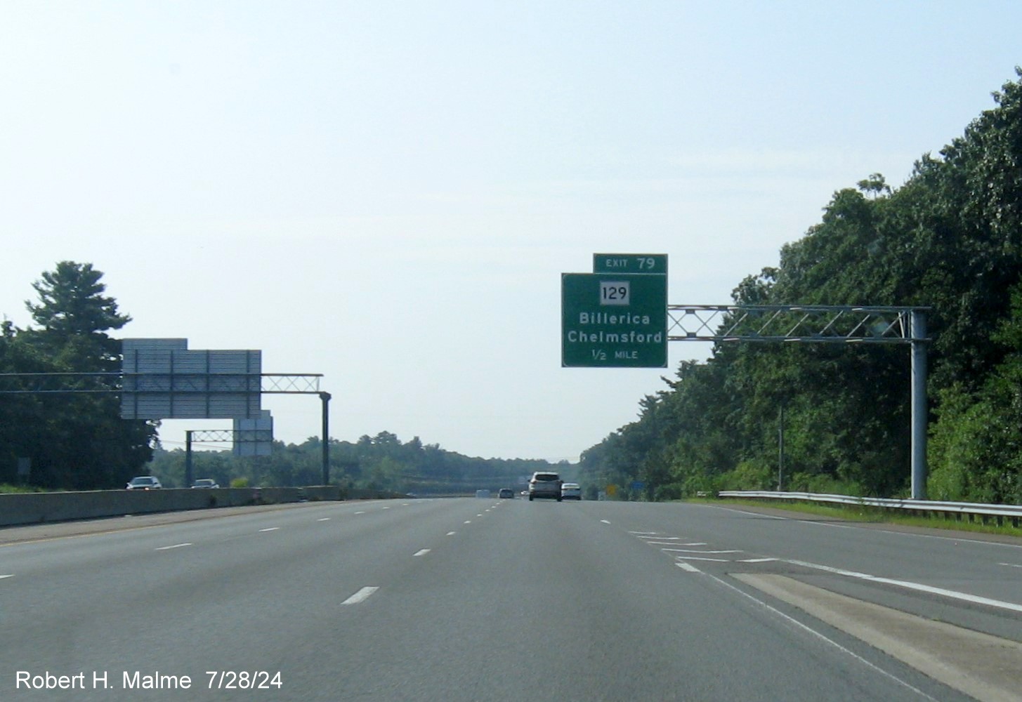 Image of recently placed 1/2 mile advance overhead sign for MA 129 exit on US 3 South in Chelmsford, July 2024