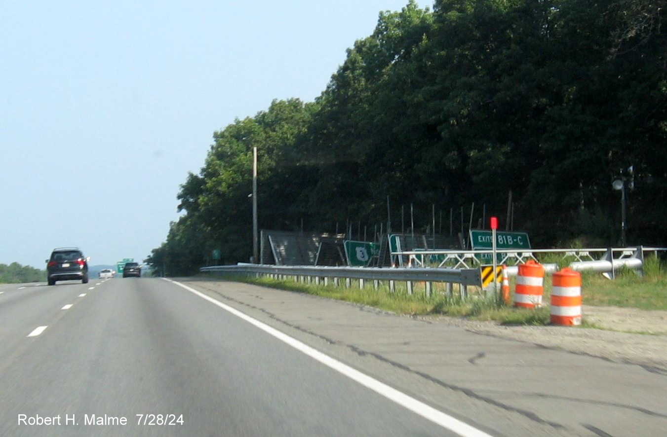 Image of remaining sign gantries and signs in staging area for sign replacement project along US 3 in Westford, July 2024