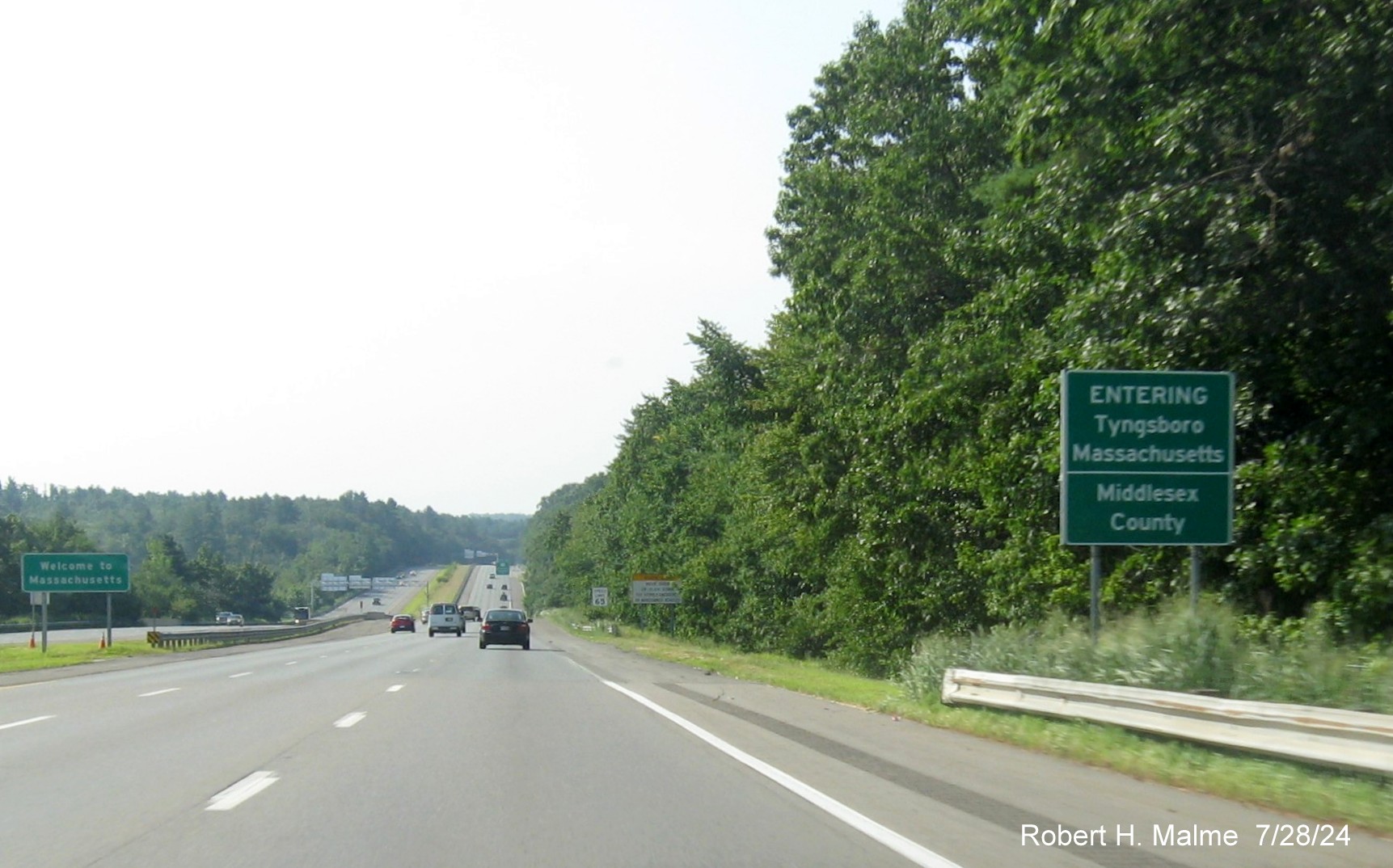 Image of recently placed state and town boundary sign prior to MA 113 exit on US 3 South, July 2024