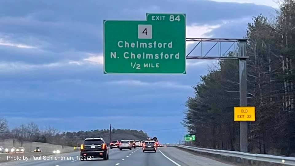 Image of 1/2 Mile advance overhead sign for MA 4 exit with new milepost based exit number and yellow Old Exit sign on right support post on US 3 South in Chelmsford, by Paul Schlichtman, January 2021