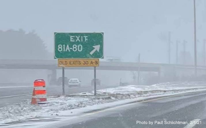 Image of gore sign for I-495 North /Lowell Connector exits with new milepost based exit numbers (backwards) and yellow old exit number sign below on US 3 North in Chelmsford, by Paul Schlichtman. February 2021