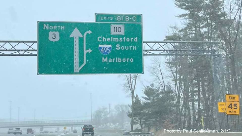Image of 1 Mile advance overhead sign for I-495 South/MA 110 exits with new milepost based exit numbers and yellow old exit number sign on support post on US 3 North in Chelmsford, by Paul Schlichtman. February 2021