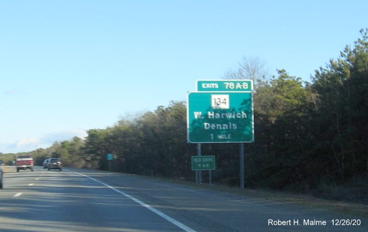 Image of 1-mile advance sign for MA 134 exits with new milepost based exit number and green old exit sign on separate posts on US 6 East in Dennis, December 2020
