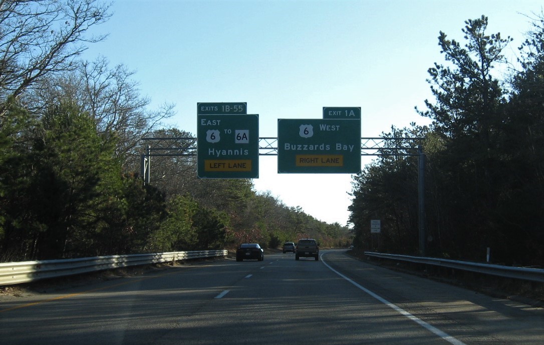 Image of 1-mile advance overhead signs for US 6 exits with milepost based exit number placed for MA 6A exit at end of MA 3 South in Bourne, December 2020
