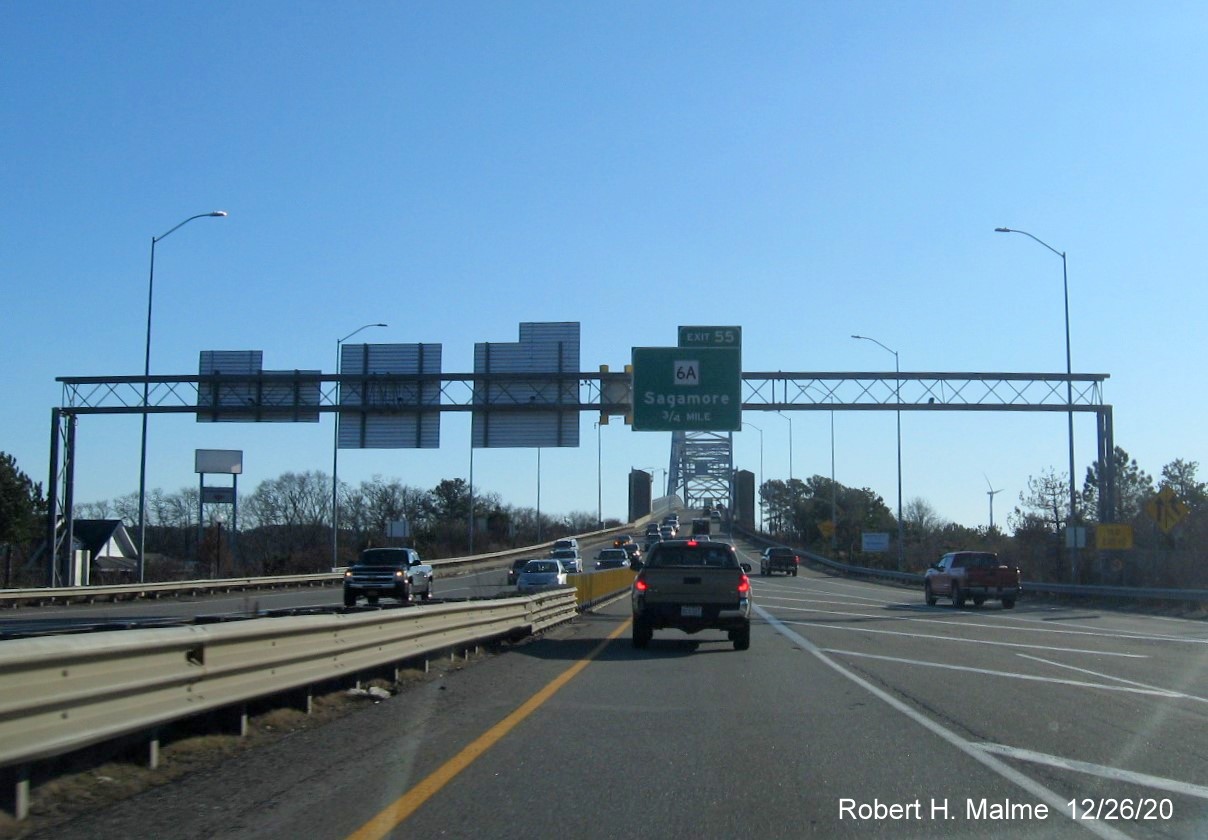 Image of 3/4 mile advance sign for MA 6A exit with new milepost based exit number and yellow old exit sign on right support post on US 6 East in Bourne, December 2020