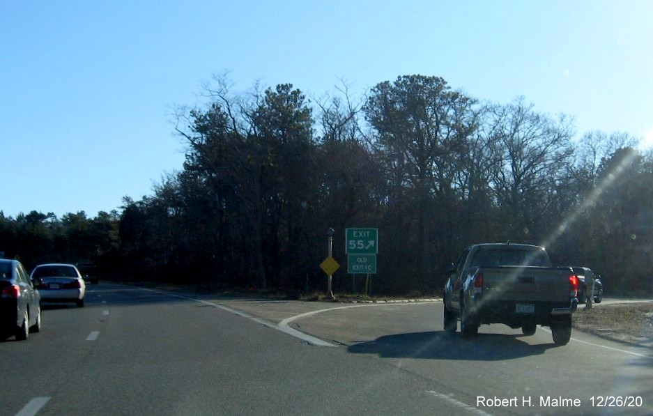 Image of gore sign for MA 6A exit with new milepost based exit number and  green old exit sign below on US 6 East in Bourne, December 2020