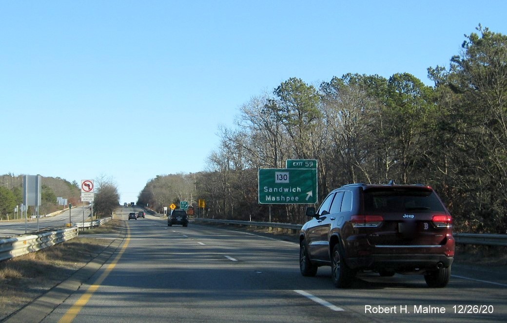 Image of ground mounted sign for MA 130 exit with new milepost based exit number and gore sign with green old exit number sign below on US 6 East in Sandwich, December 2020