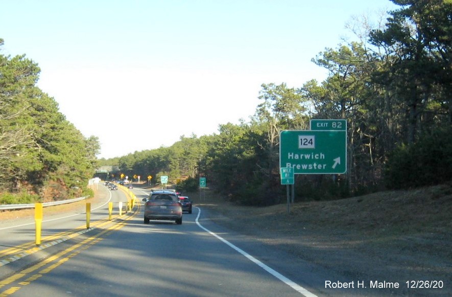 Image of ground mounted ramp sign for MA 124 exit with new milepost based exit number on US 6 East in Harwich, December 2020