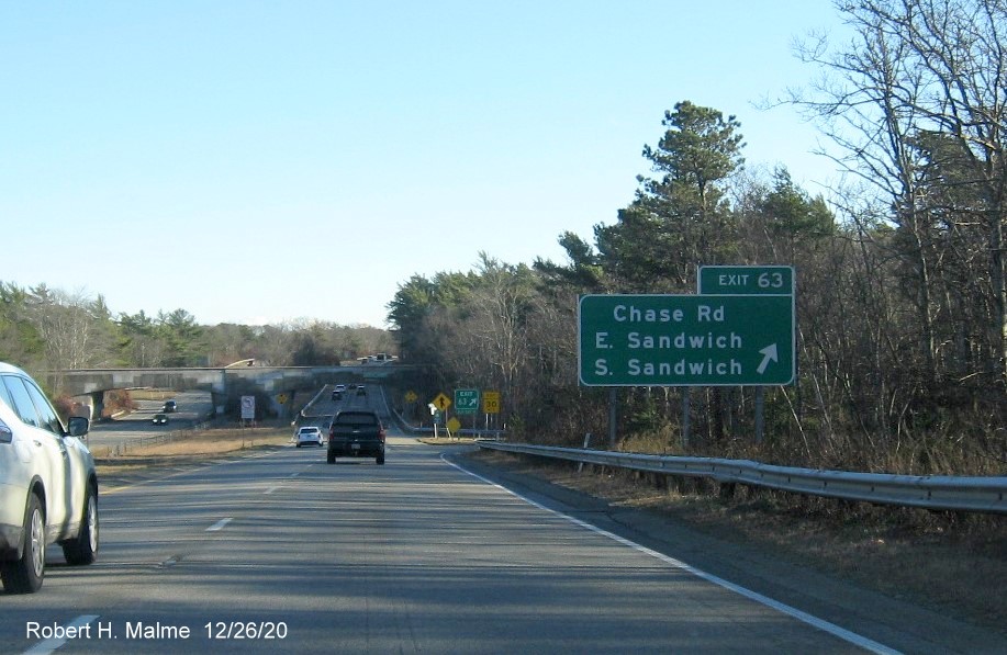 Image of ground mounted ramp sign for Chase Road exit with new milepost based exit number and green old exit sign below on US 6 East in Sandwich, December 2020
