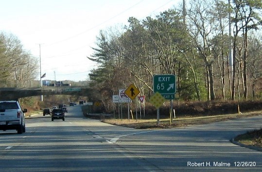 Image of gore sign for MA 149 exit with new milepost based exit number and green old exit sign below on US 6 East in Barnstable, December 2020