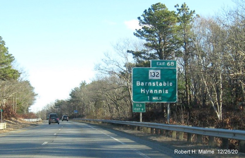 Image of 1-Mile advance sign for MA 132 exit with new milepost based exit number and green old exit number sign on left support post on US 6 East in Barnstable, December 2020