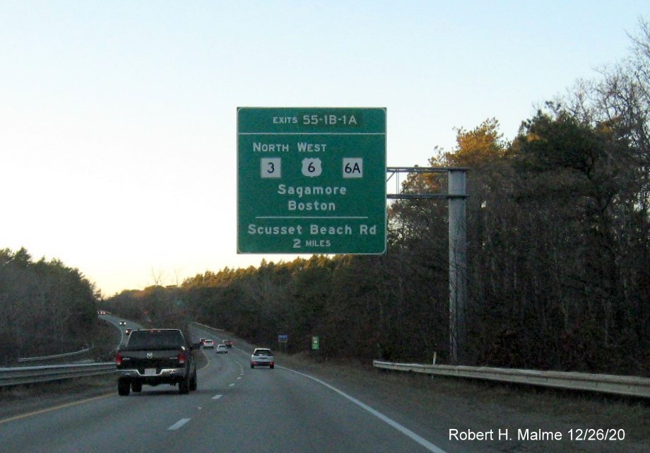 Image of 2 miles advance overead sign for MA 3 and MA 6A exits with new milepost based exit number on US 6 West in Bourne, December 2020
