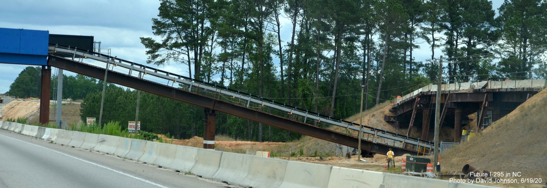 View of conveyor belt for dirt being carried across I-95 from besides northbound lanes at site of 
        future I-295 interchange near Hope Mills, by David Johnson June 2020