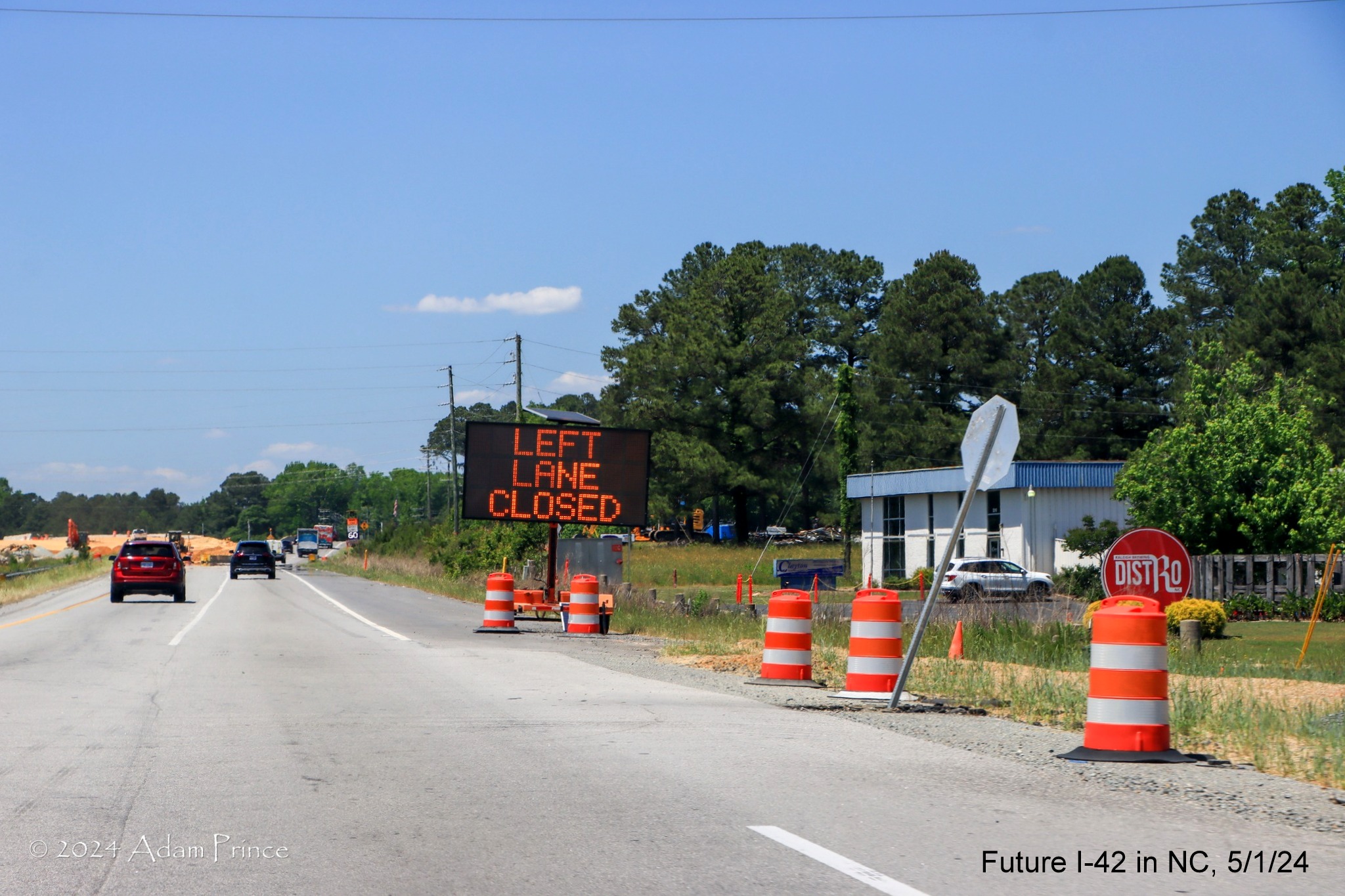 Image of US 70 (Future I-42) West traffic approaching left lane closure ahead of future exit ramp to 
        access Wilson's Mills Road intersection, by Adam Prince, May 2024