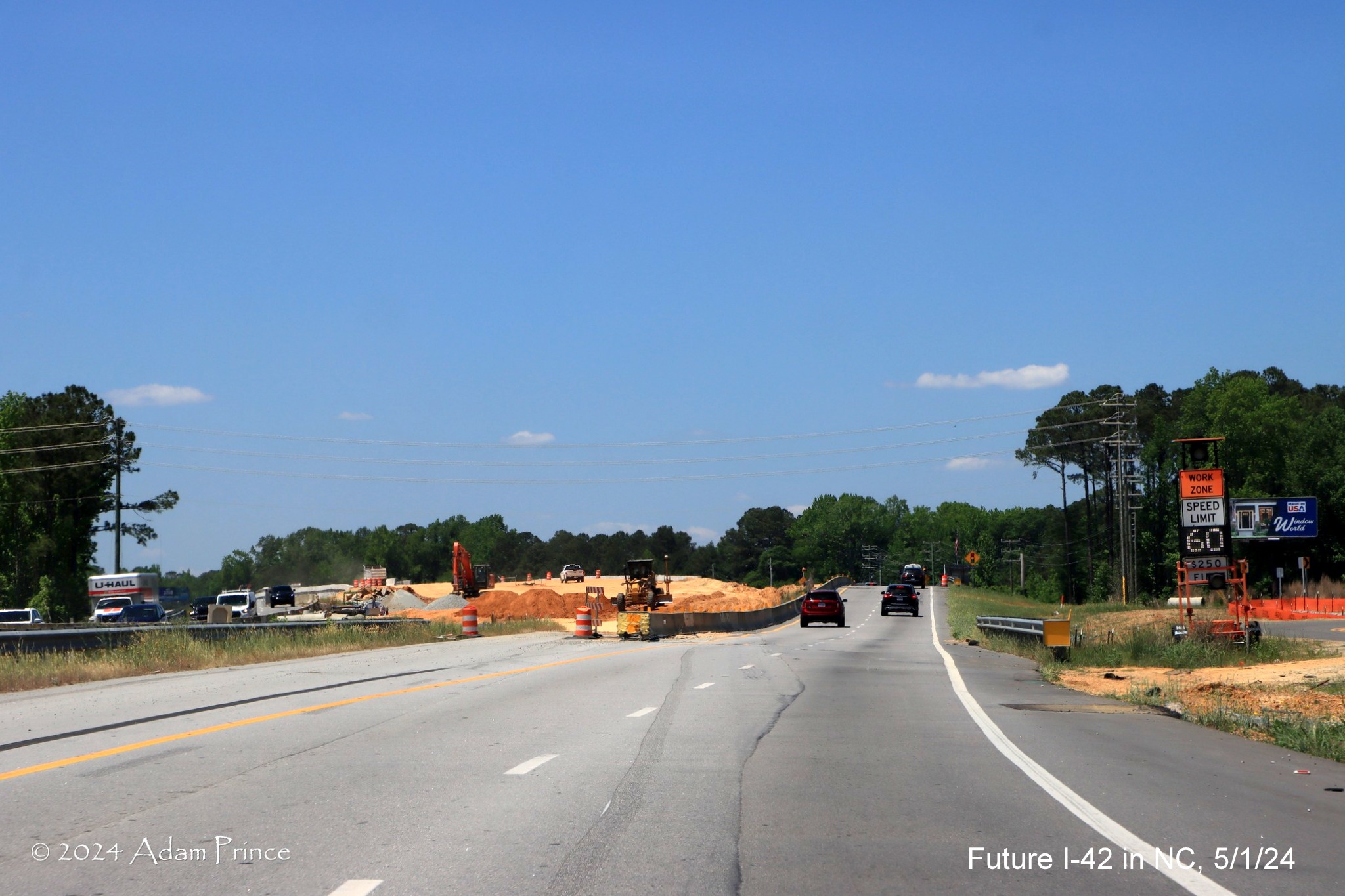 Image of US 70 (Future I-42) West traffic using future exit ramp to 
        access Wilson's Mills Road intersection, by Adam Prince, May 2024