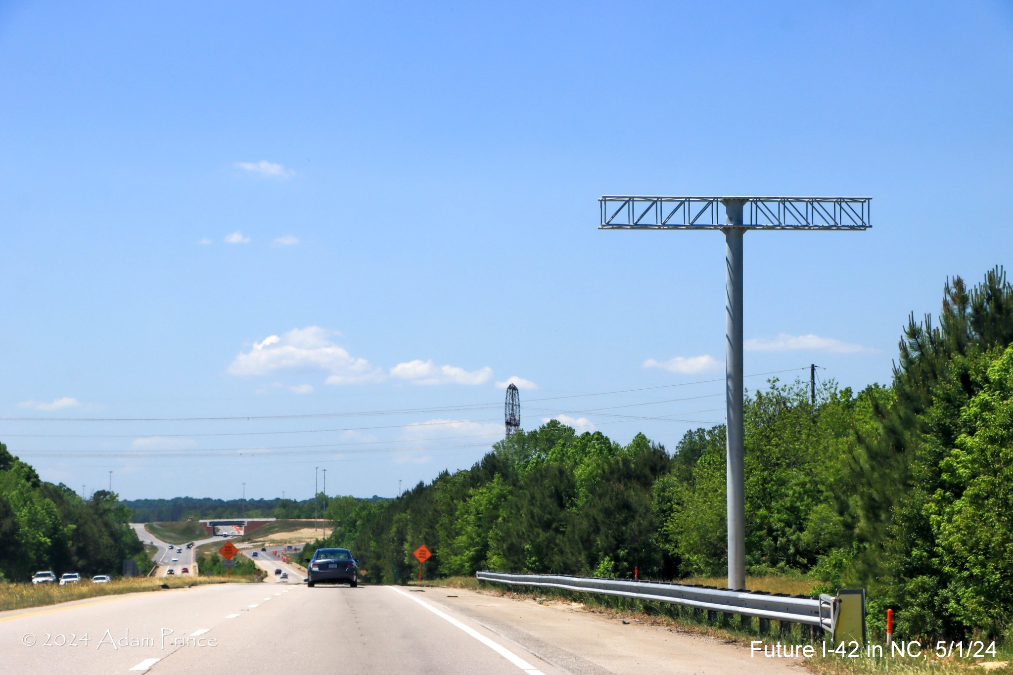 Image of gantry for future overhead VMS on US 70 (Future I-42) West approaching the I-40/NC 540 turbine interchange, by Adam Prince, May 2024