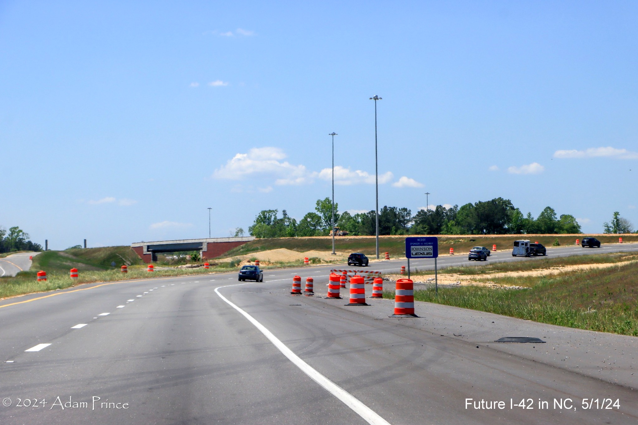 Image of US 70 (Future I-42) West lanes curving to approach the I-40/NC 540 turbine interchange ramps, by Adam Prince, May 2024