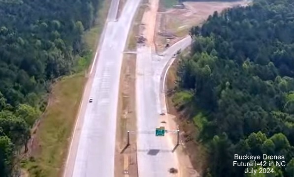 Screen grab image from Buckeye Drones video of new overhead signage with I-40 and US 70 shields on 
       Future NC 540 East at NC 50 interchange, July 2024