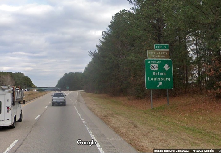 Image of ground mounted exit sign for Alt US 264/NC 39 exit with new I-587 milepost exit number on US 264 East in Zebulon, Google Maps Street View, December 2022