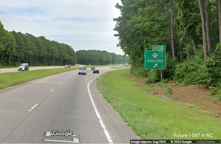 Image of ground mounted 1/2 mile advance sign for NC 97 exit with new I-587 milepost exit number on US 264 East in Zebulon, Google Maps Street View, December 2022